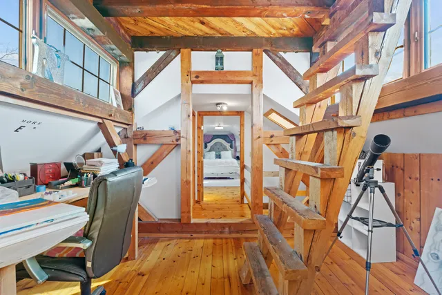a living room with a bed furniture and a window