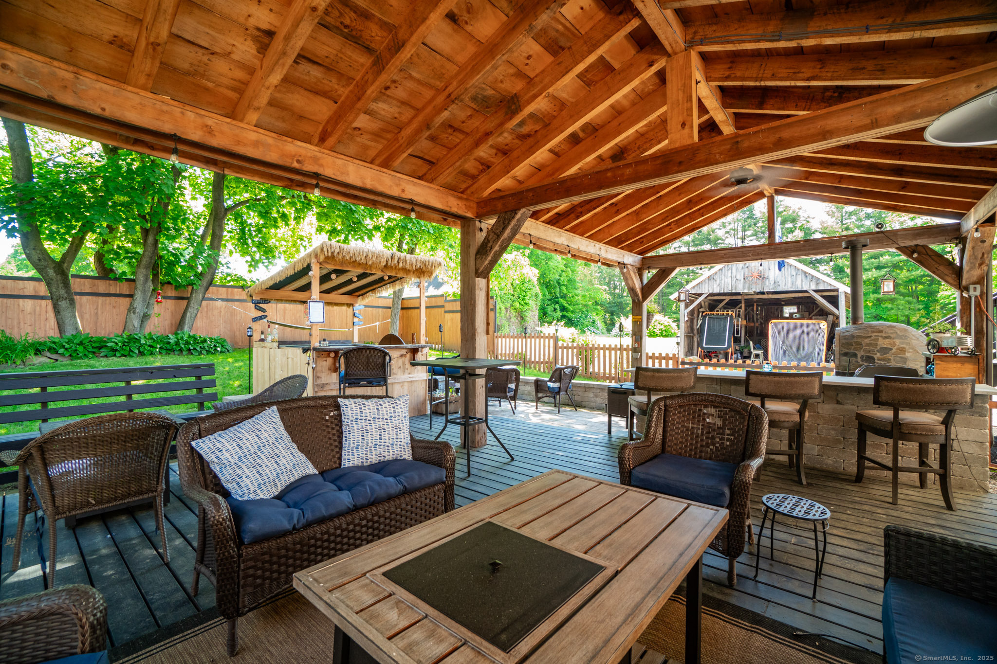 26 Old Wallingford Road Durham, CT 06422 - Photo 3 of 38 a view of a patio with couches table and chairs under an umbrella with a barbeque grill and couches