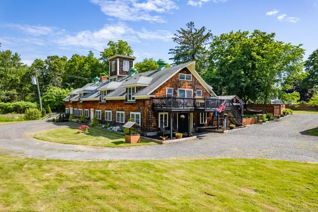 a view of a swimming pool with a lawn chairs and plants