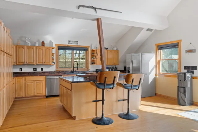 a kitchen with stainless steel appliances granite countertop a stove oven and a refrigerator