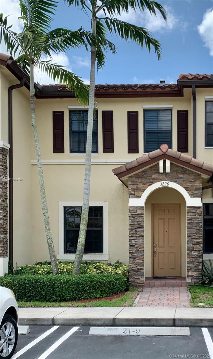 3220 Southeast 7th Street, Unit 2 Homestead, FL 33033 - Photo 1 of 2 a front view of a house with a yard and garage