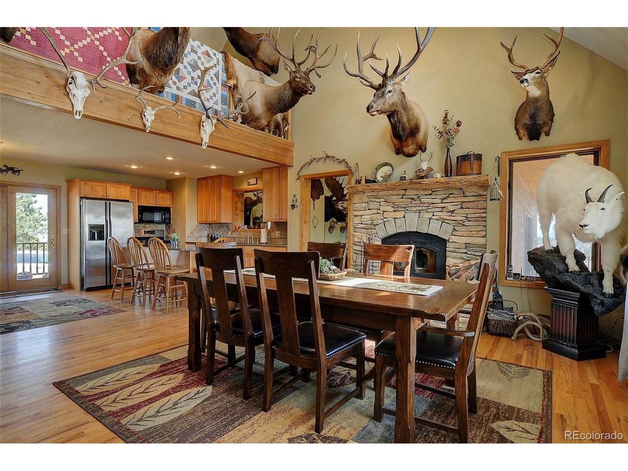 1251 Antelope Trail Cotopaxi, CO 81223 - Photo 11 of 38 a dining room with furniture wooden floor a fireplace and a chandelier