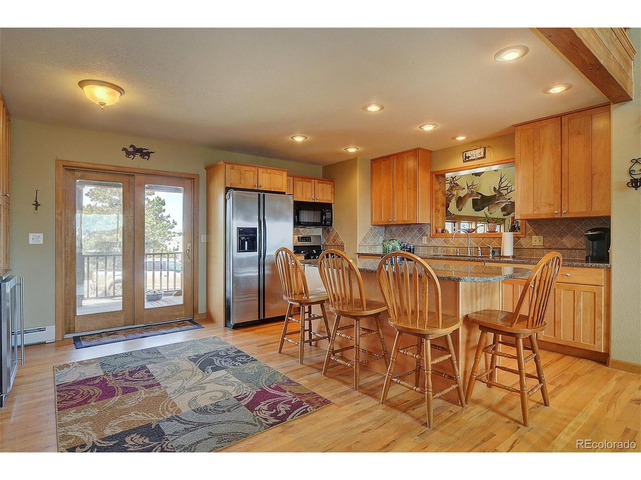 1251 Antelope Trail Cotopaxi, CO 81223 - Photo 12 of 38 a open kitchen with stainless steel appliances granite countertop a refrigerator dining table and chairs