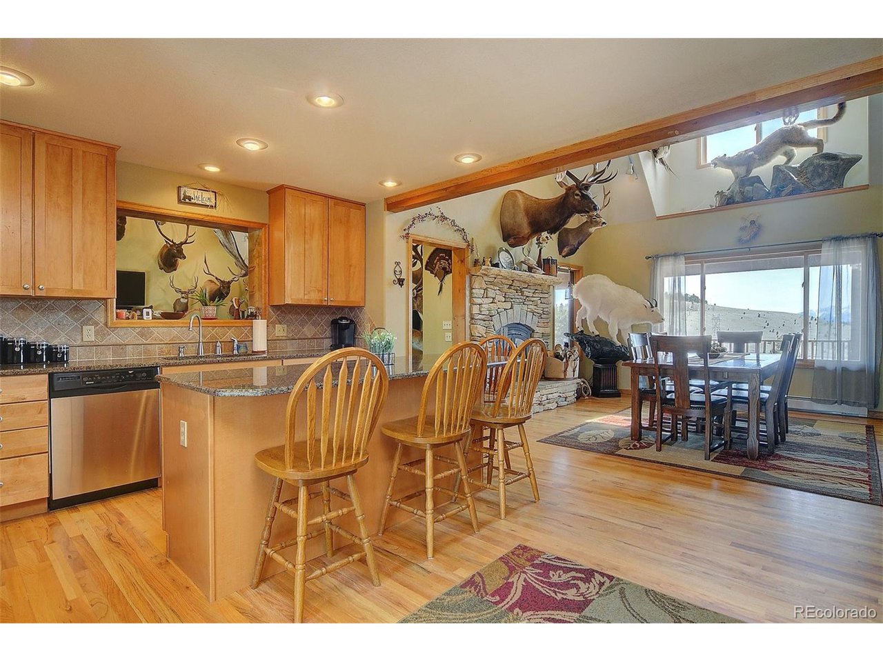 1251 Antelope Trail Cotopaxi, CO 81223 - Photo 14 of 38 a kitchen with stainless steel appliances kitchen island granite countertop a table and chairs