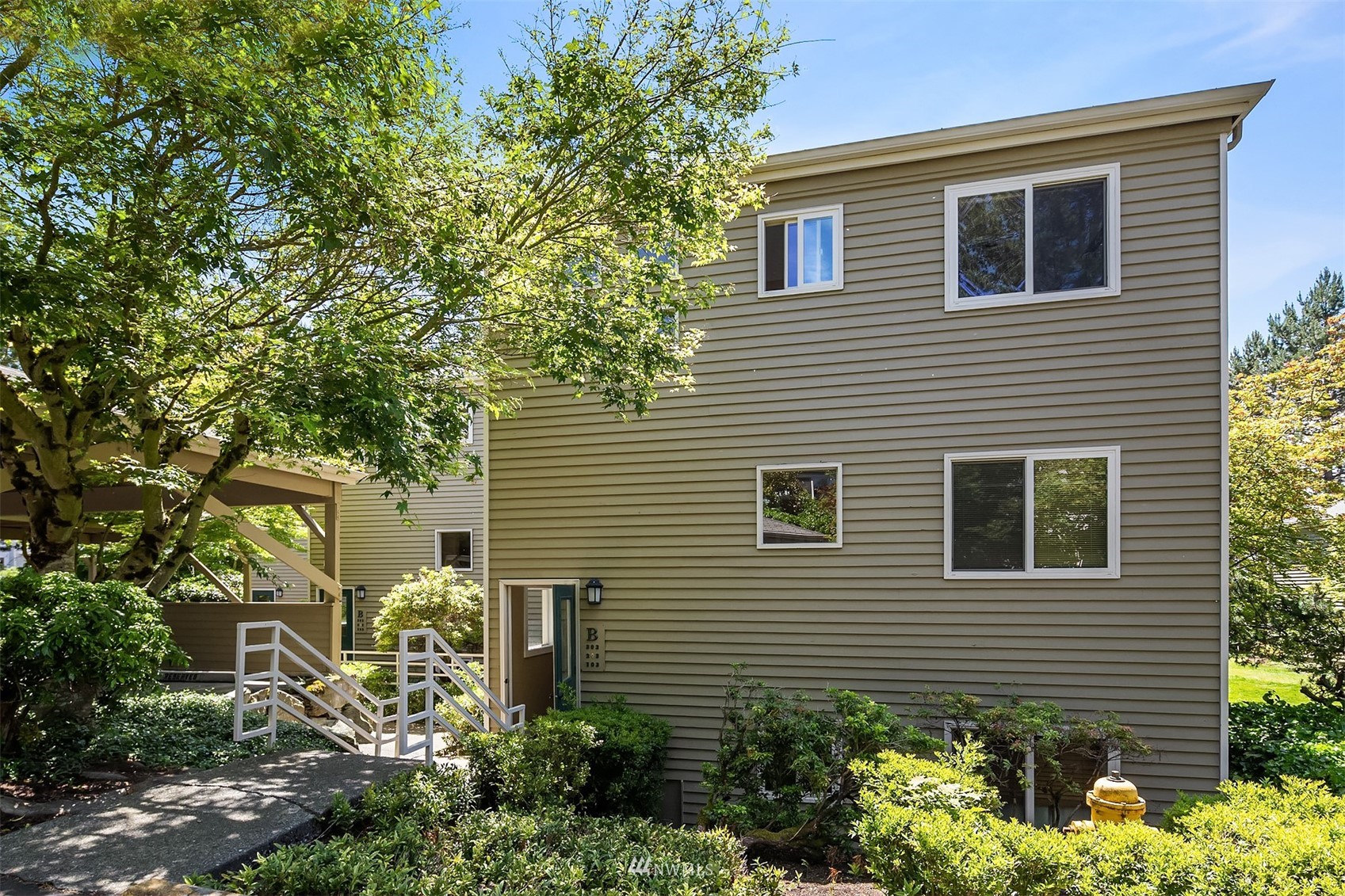 605 5th Street, Unit B 303 Kirkland, WA 98033 - Photo 1 of 18 a view of a house with a yard and potted plants