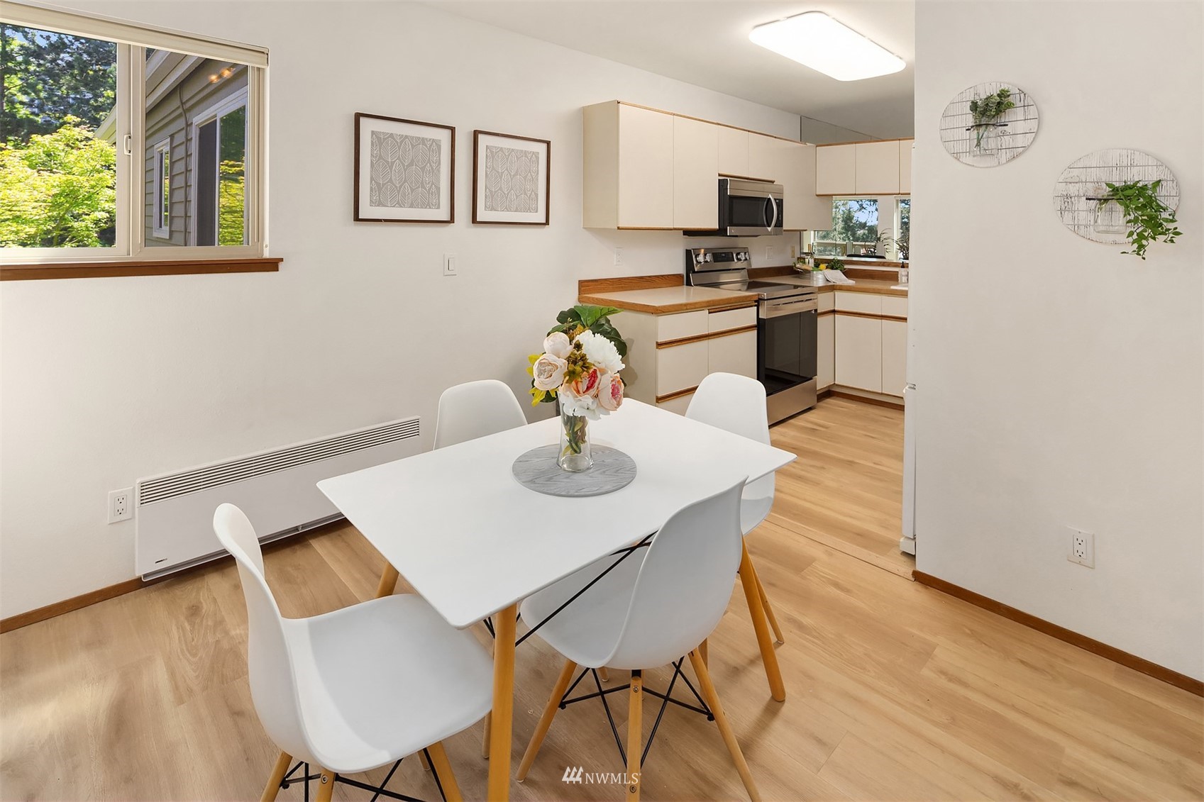 605 5th Street, Unit B 303 Kirkland, WA 98033 - Photo 8 of 18 a view of a dining room with furniture and wooden floor