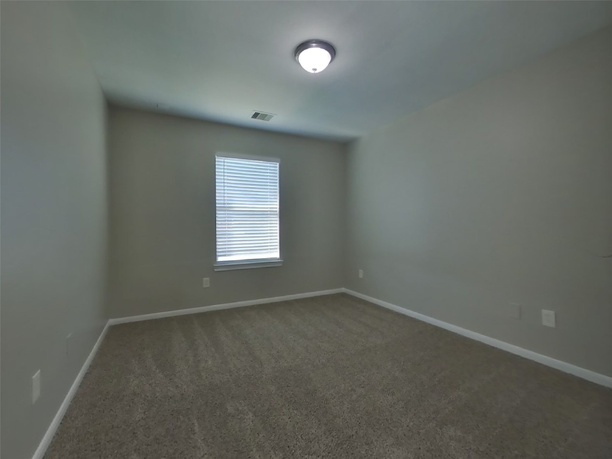 11415 Carla Street Houston, TX 77076 - Photo 12 of 15 an empty room with a window and a fan