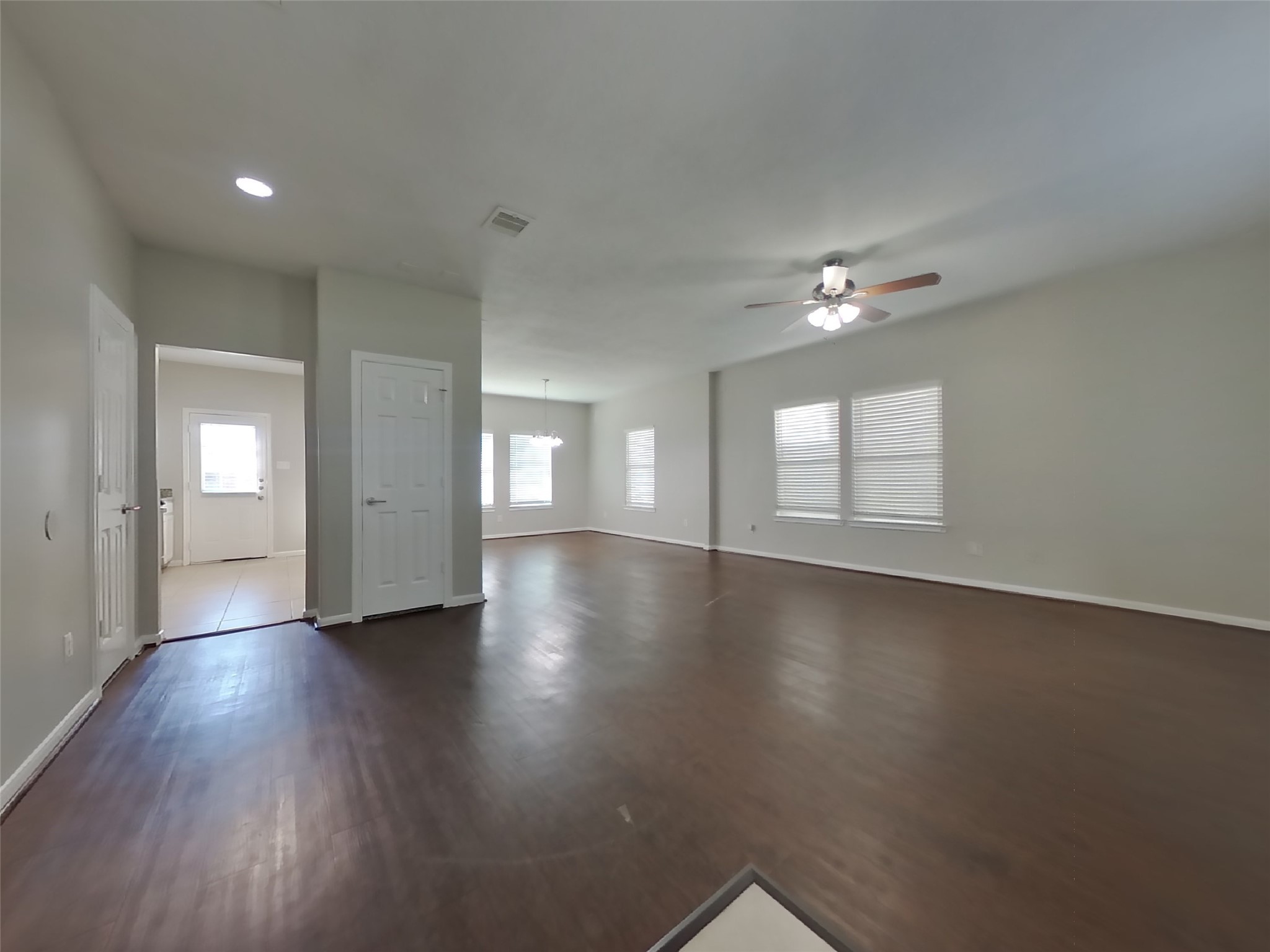 11415 Carla Street Houston, TX 77076 - Photo 3 of 15 an empty room with wooden floor and windows
