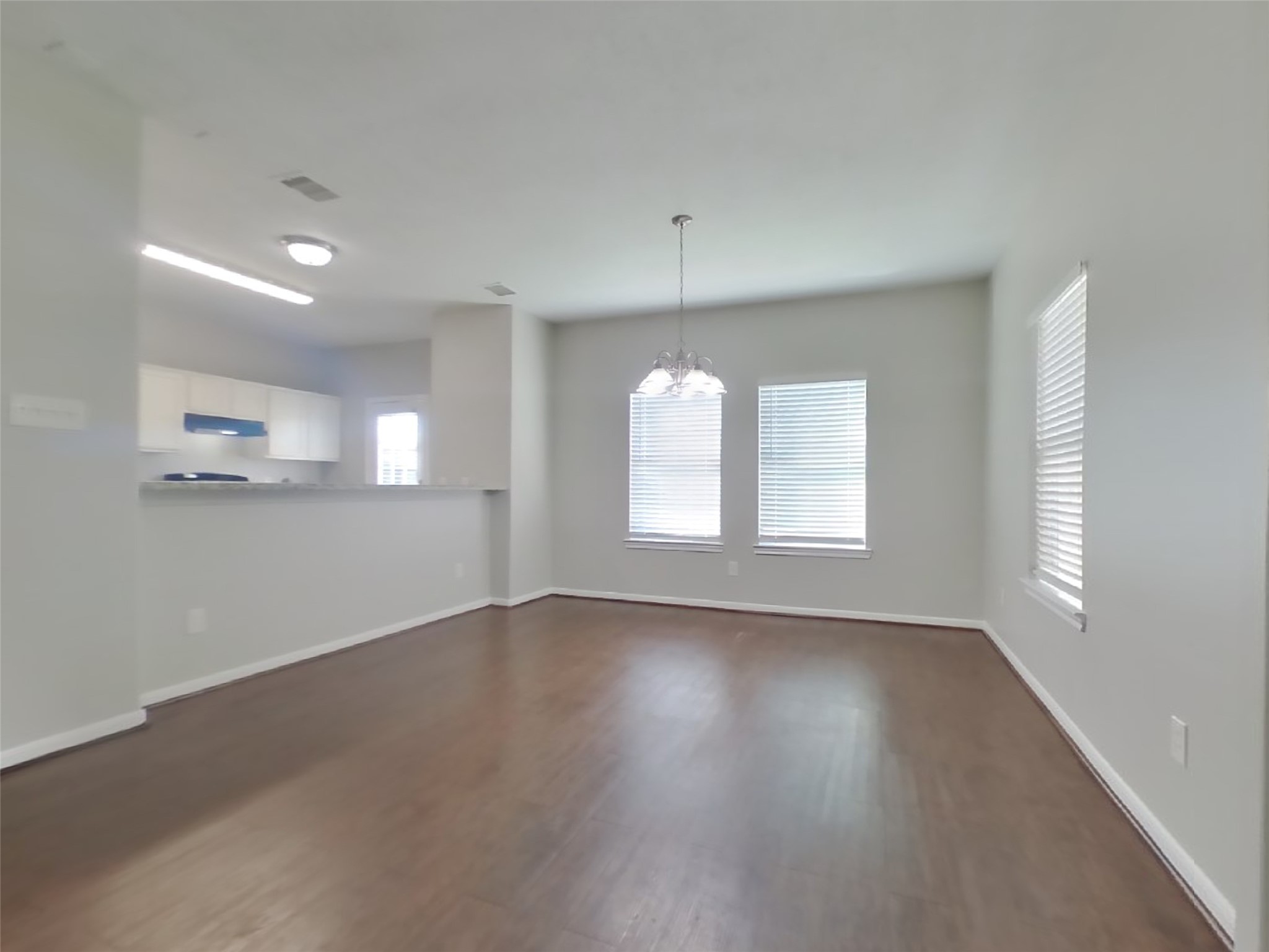 11415 Carla Street Houston, TX 77076 - Photo 6 of 15 a view of an empty room with wooden floor and a window