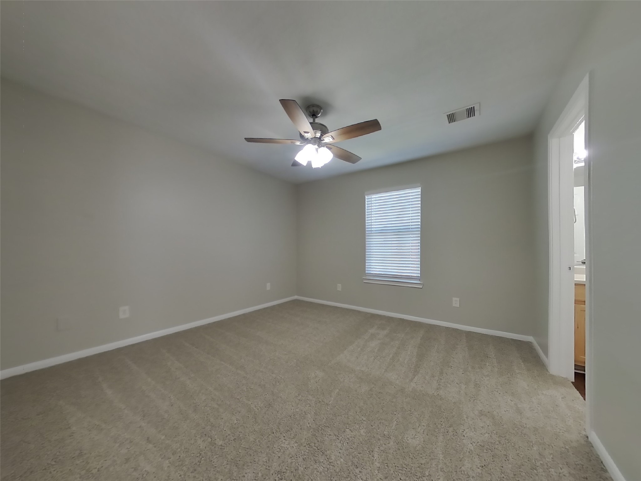 11415 Carla Street Houston, TX 77076 - Photo 8 of 15 an empty room with a window and a ceiling fan