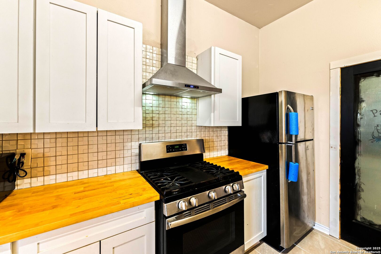 2211 Geneva Street Castroville, TX 78009 - Photo 11 of 41 a kitchen with stainless steel appliances a stove and a refrigerator