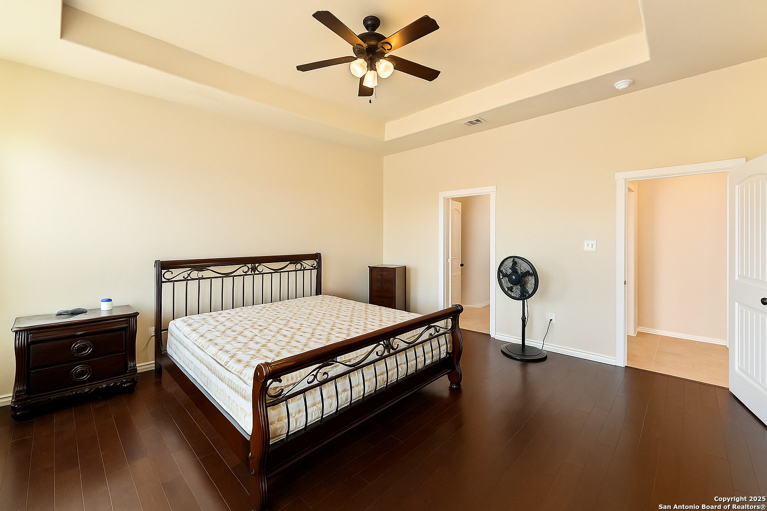 2211 Geneva Street Castroville, TX 78009 - Photo 13 of 41 a bedroom with a bed and a chandelier
