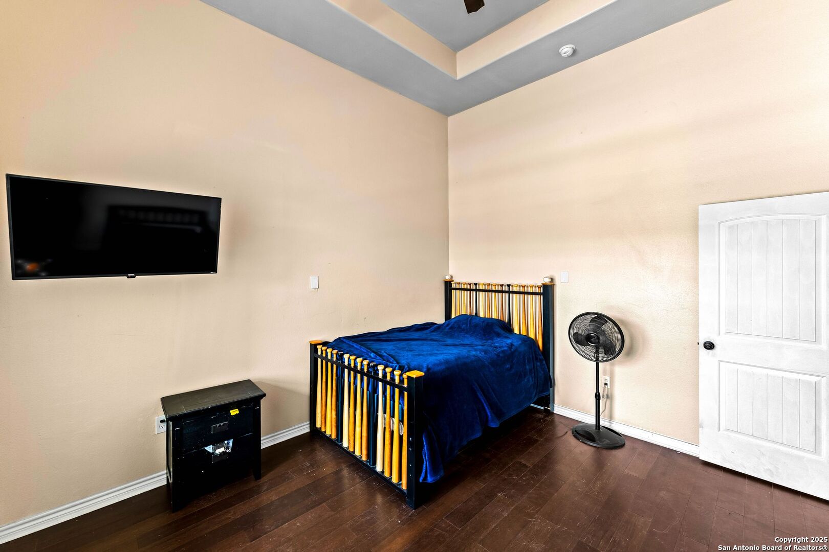 2211 Geneva Street Castroville, TX 78009 - Photo 17 of 41 a bedroom with a bed and a flat tv screen on dresser