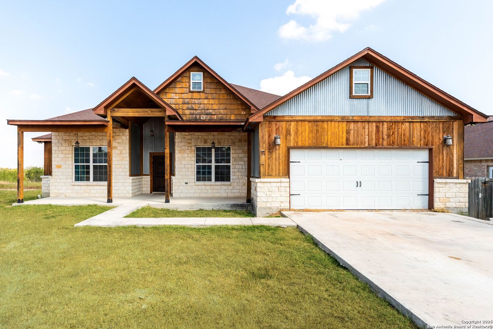 2211 Geneva Street Castroville, TX 78009 - Photo 2 of 41 a front view of a house with a yard and garage