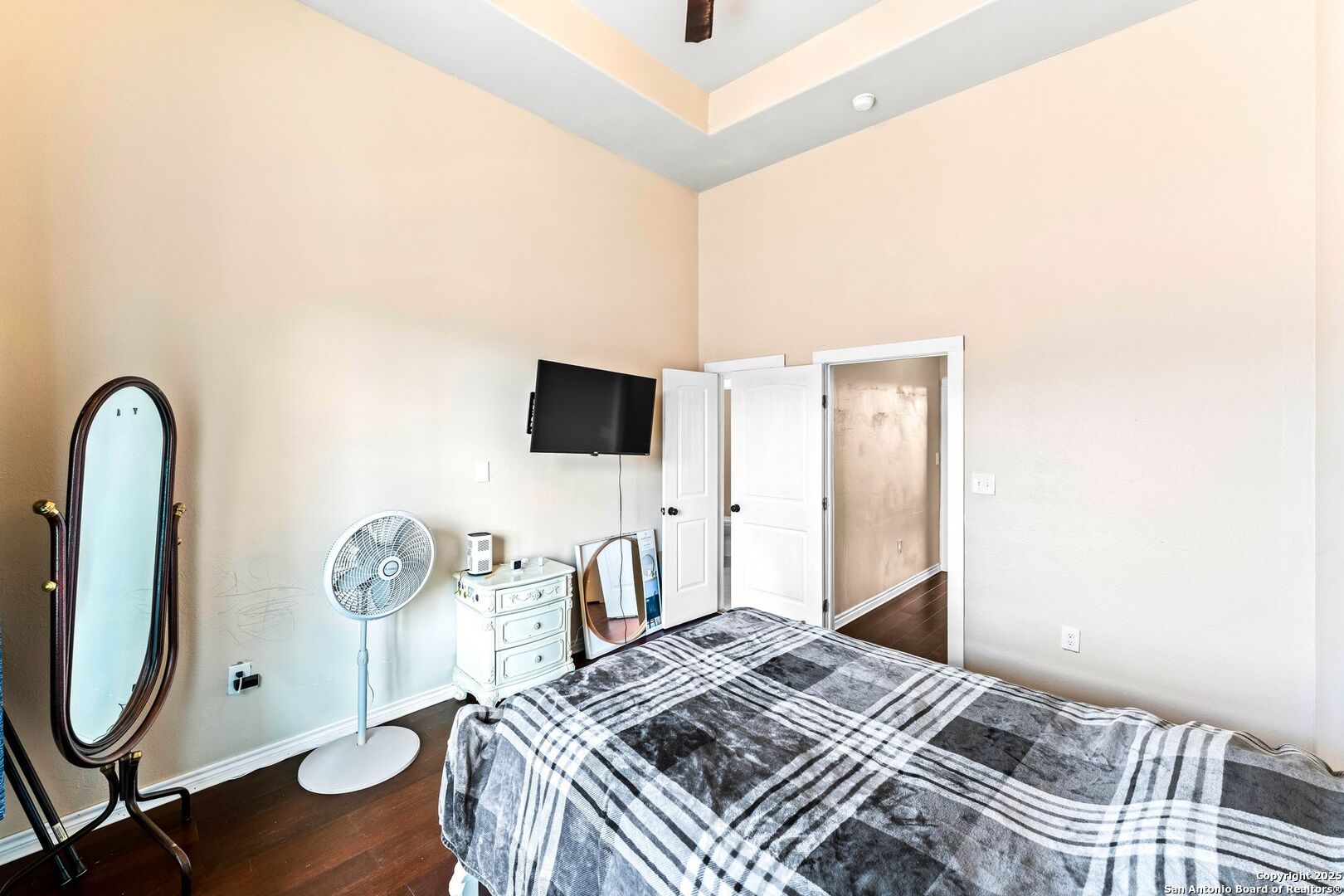 2211 Geneva Street Castroville, TX 78009 - Photo 22 of 41 a bedroom with a bed and a flat screen tv