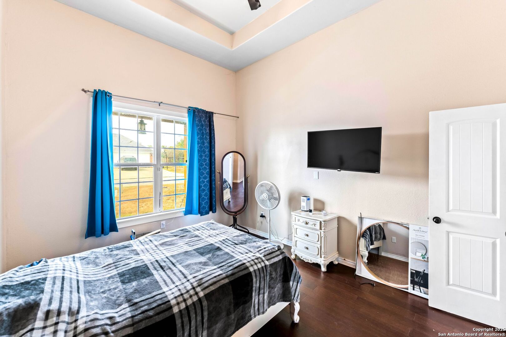 2211 Geneva Street Castroville, TX 78009 - Photo 24 of 41 a bedroom with a bed and a flat screen tv