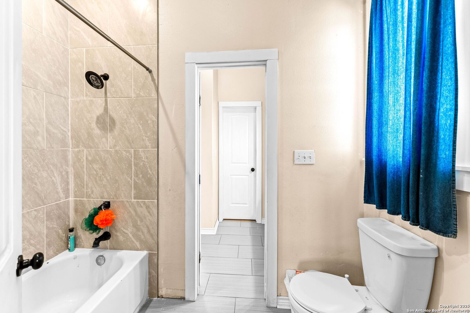 2211 Geneva Street Castroville, TX 78009 - Photo 25 of 41 a bathroom with a sink a toilet and shower curtain