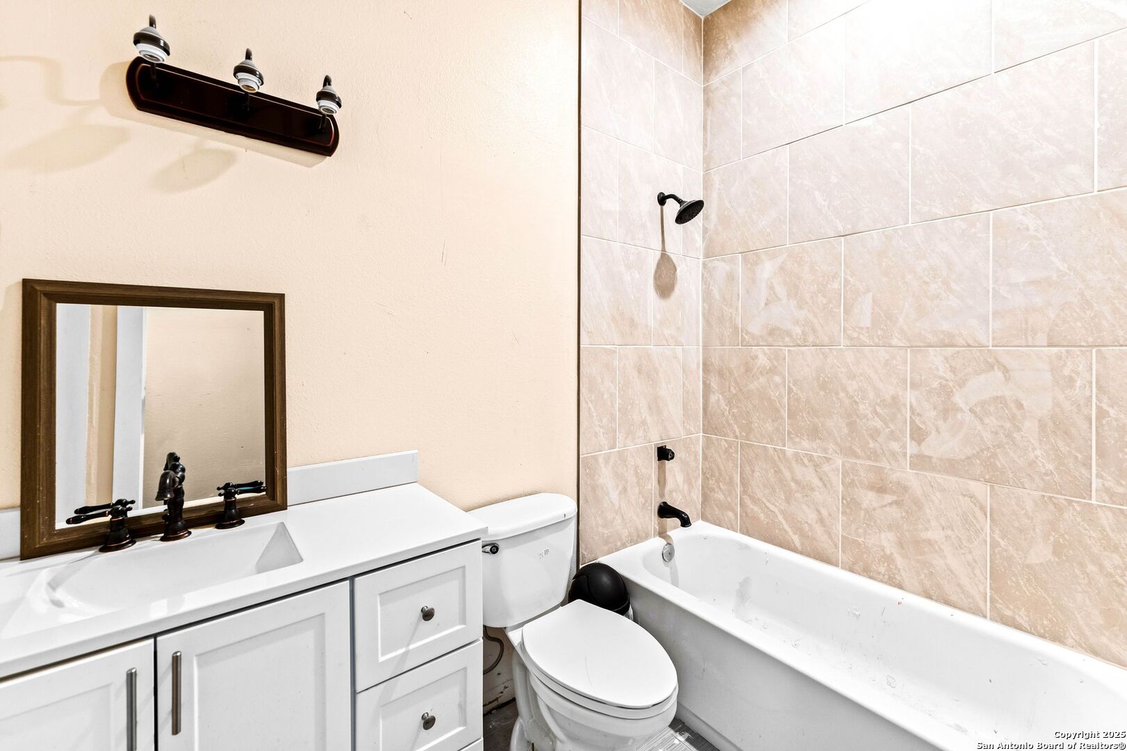 2211 Geneva Street Castroville, TX 78009 - Photo 29 of 41 a bathroom with a toilet a sink and a bathtub