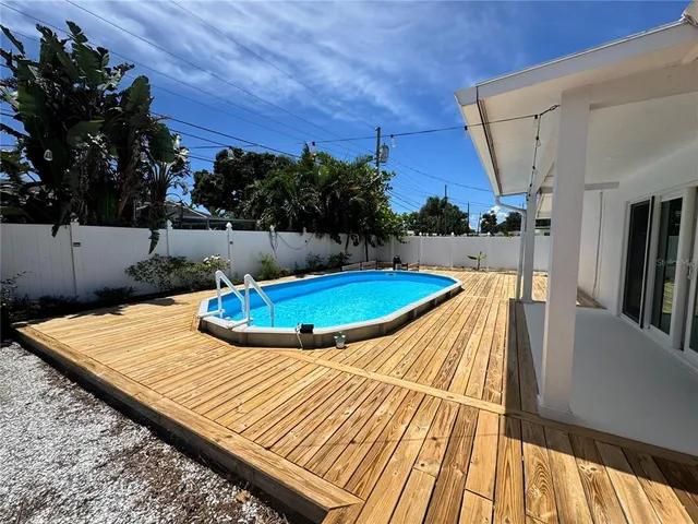a view of a backyard with sitting area