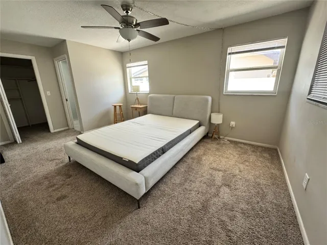 a bed sitting in a room next to a window