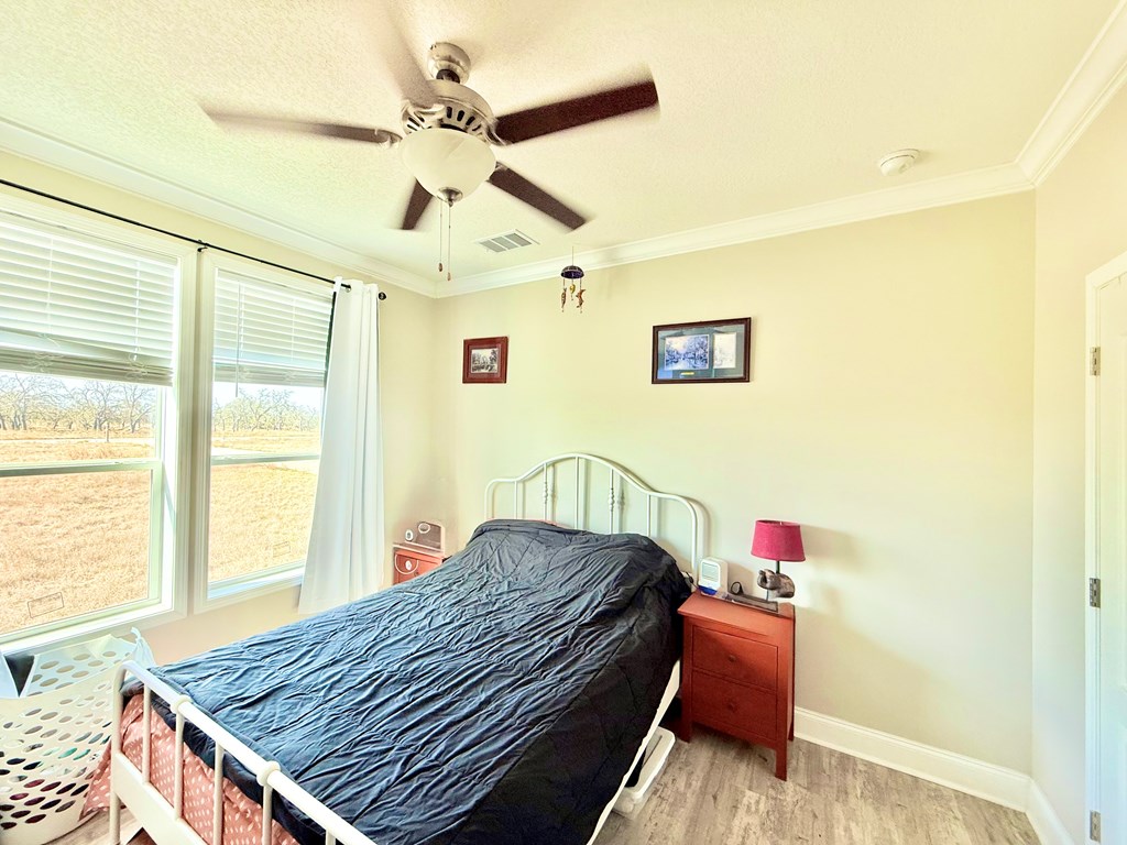 589 Scott Branch Road Harper, TX 78631 - Photo 14 of 21 a bedroom with a bed and a chandelier