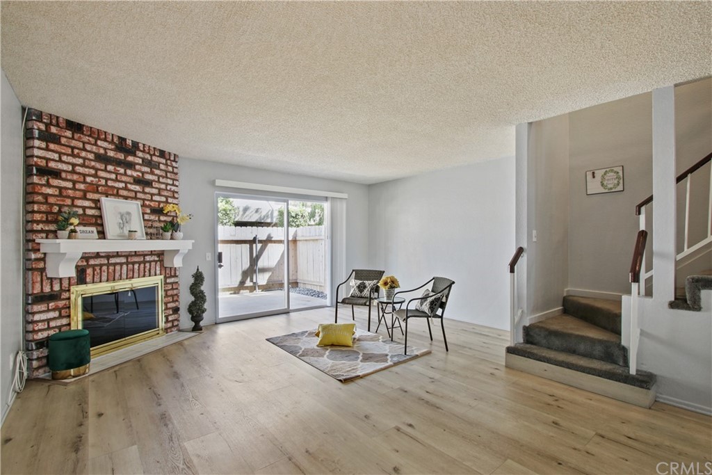 14917 Leffingwell Road, Unit 9 Whittier, CA 90604 - Photo 1 of 1 Living room with cozy fireplace and view out the patio.