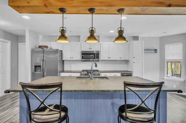 a kitchen with sink cabinets and stove