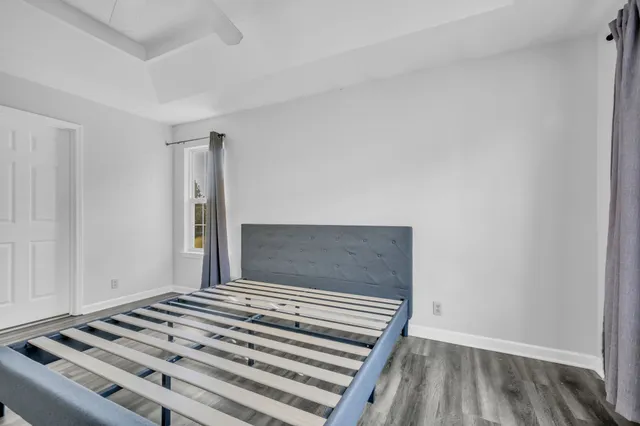 a view of an empty room and wooden floor