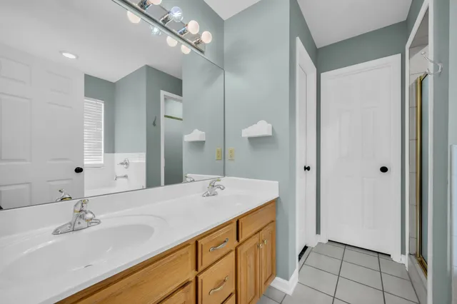 a spacious bathroom with a sink double vanity and a mirror