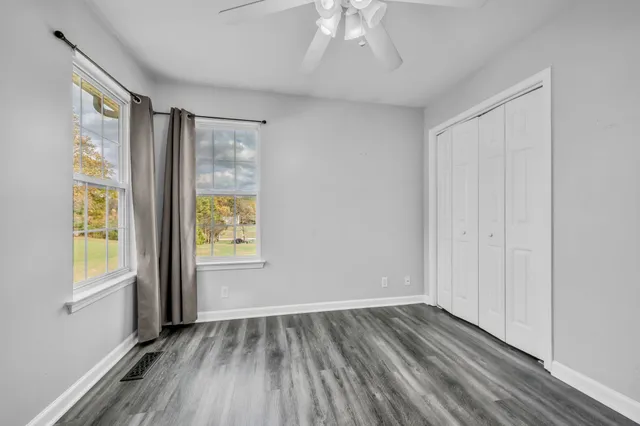 wooden floor in an empty room with a window
