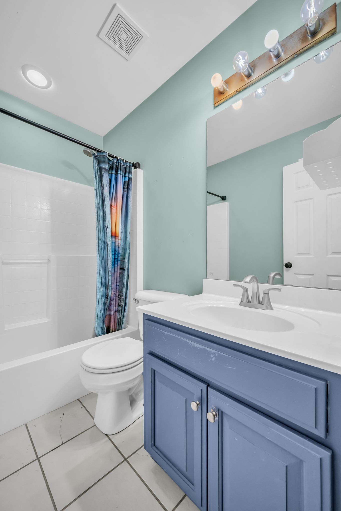 1345 Nails Creek Road Dickson, TN 37055 - Photo 26 of 27 a bathroom with a sink a toilet a mirror a bathtub and shower