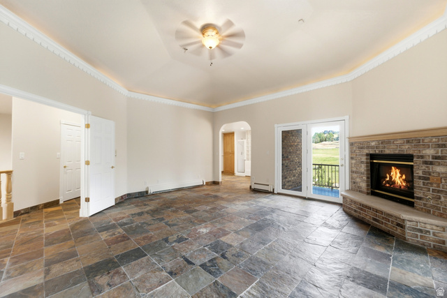 3535 Homestead Road Park City, UT 84098 - Photo 27 of 81 Spacious room featuring slate tile flooring, a brick fireplace with a hearth, double French doors, and a ceiling fan with integrated lighting