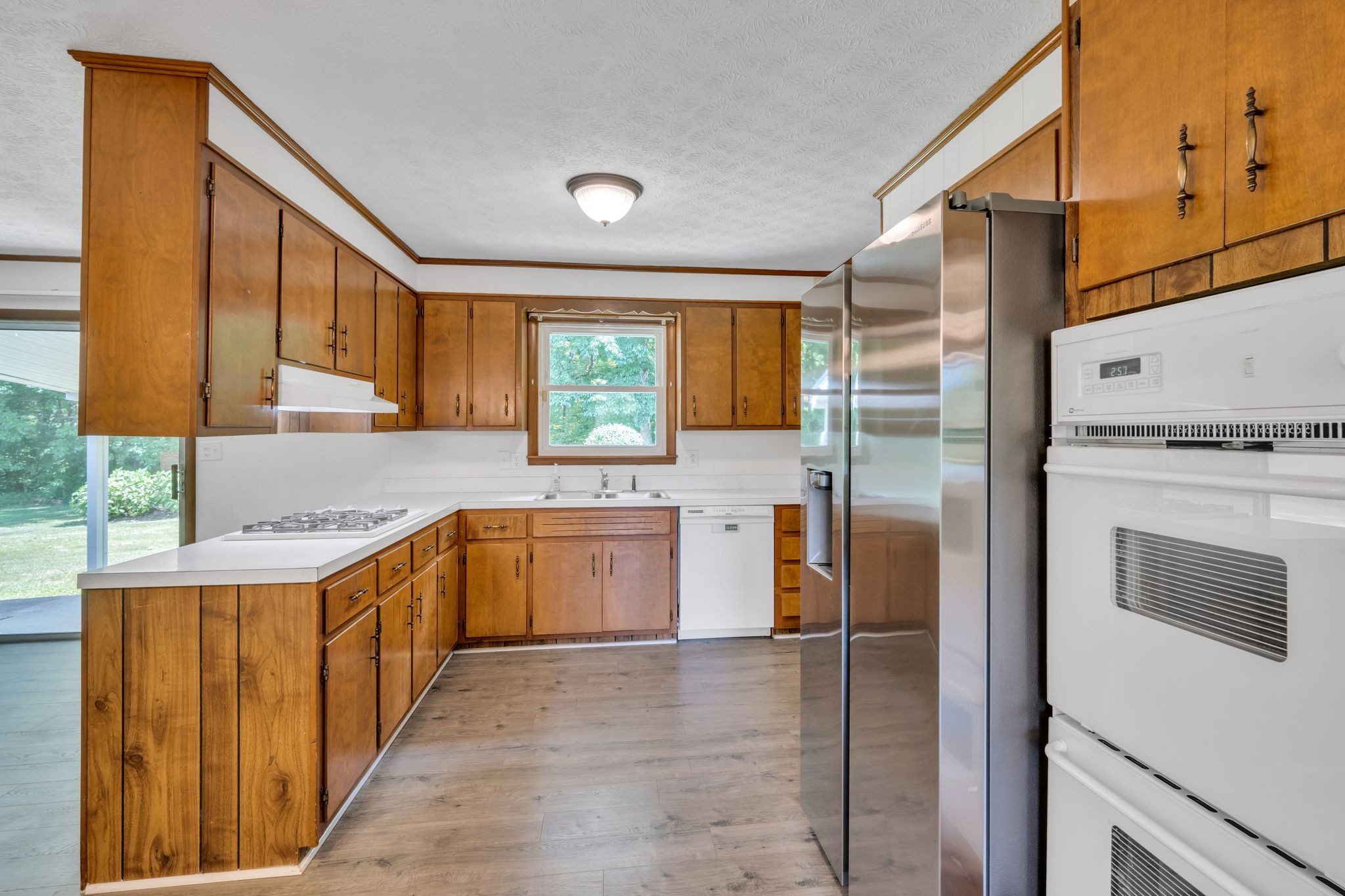 1300 2 Mile Road Burns, TN 37029 - Photo 14 of 38 a kitchen with stainless steel appliances granite countertop a refrigerator a stove and a sink