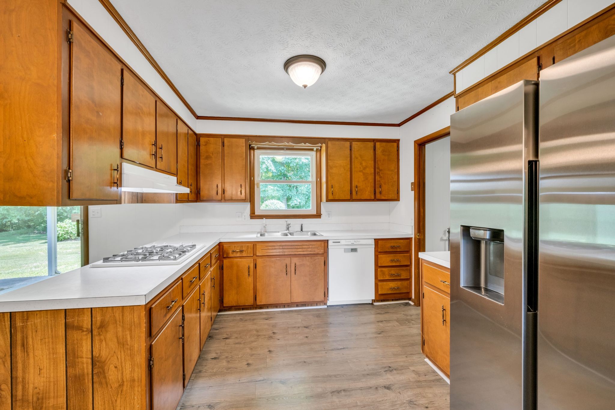 1300 2 Mile Road Burns, TN 37029 - Photo 15 of 38 a kitchen with stainless steel appliances granite countertop a sink and a refrigerator
