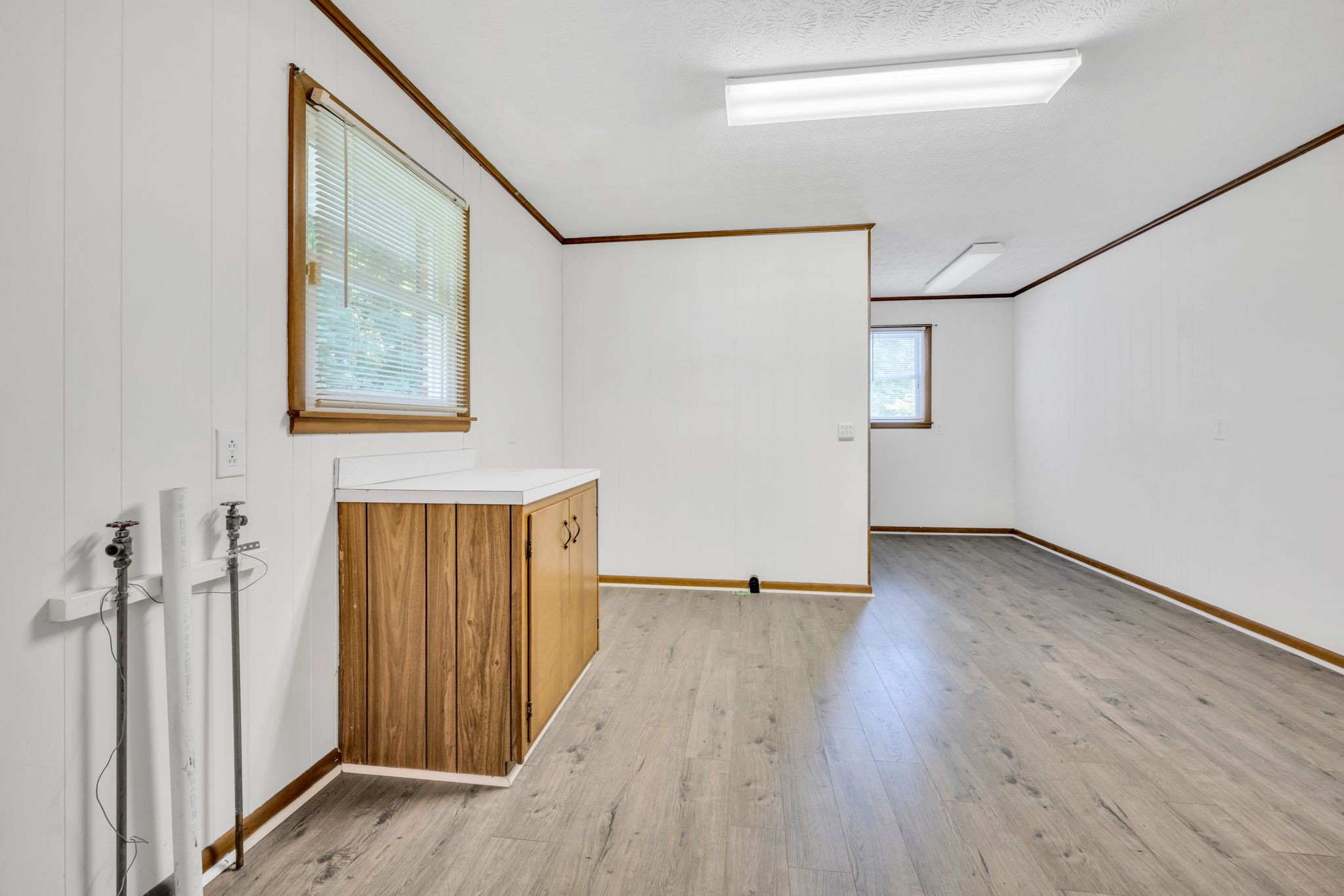 1300 2 Mile Road Burns, TN 37029 - Photo 17 of 38 an empty room with wooden floor and windows