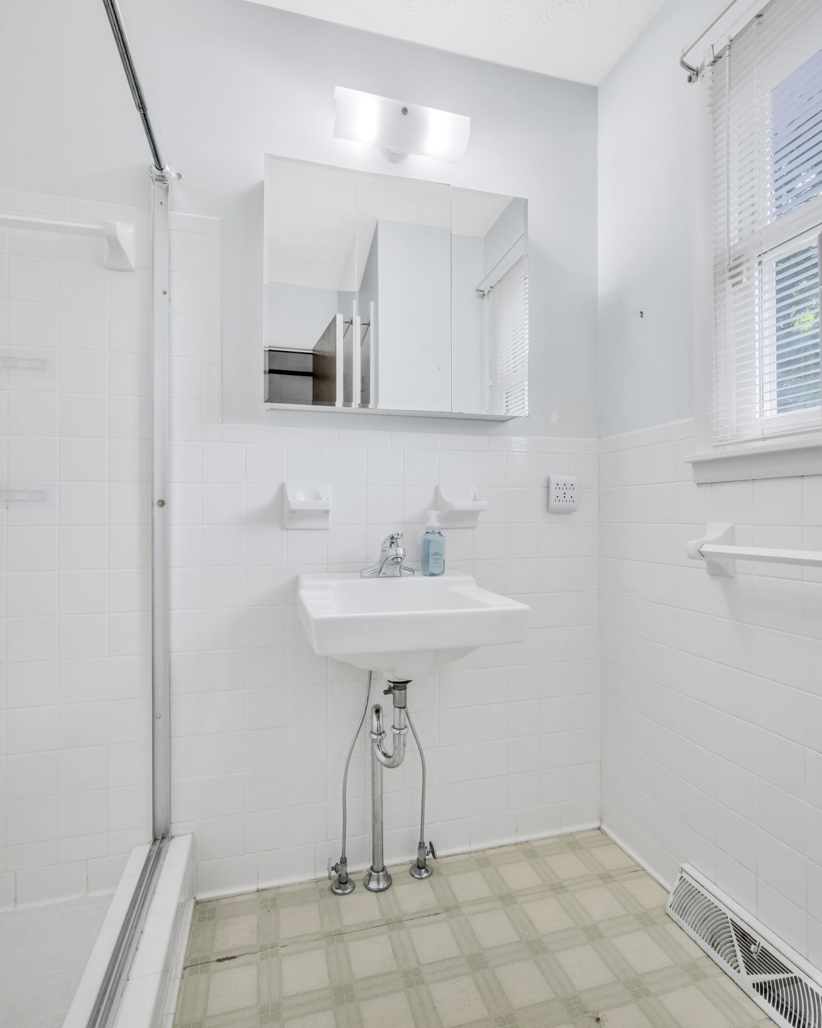 1300 2 Mile Road Burns, TN 37029 - Photo 18 of 38 a bathroom with a sink a mirror and a shower