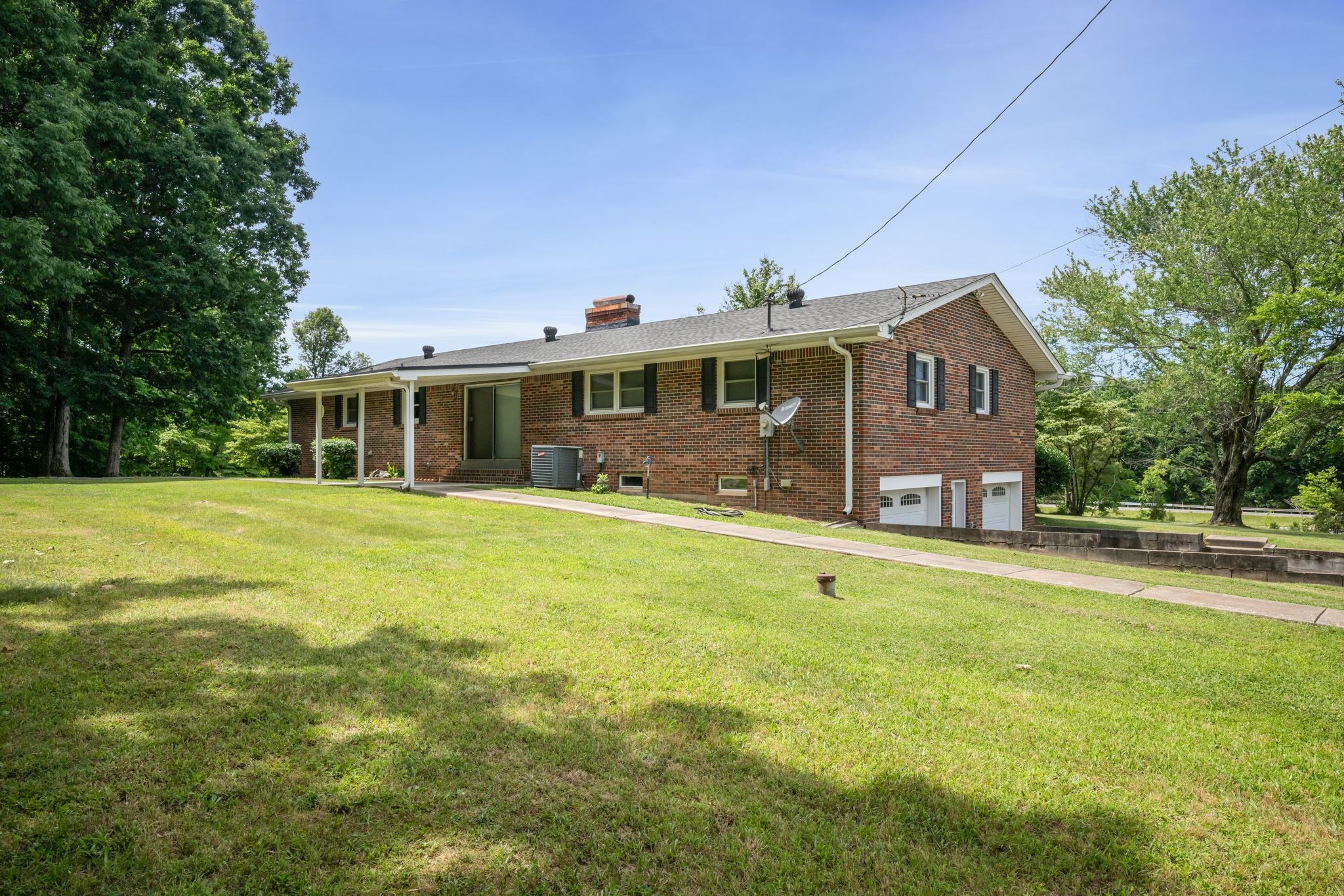 1300 2 Mile Road Burns, TN 37029 - Photo 35 of 38 a front view of a house with a garden