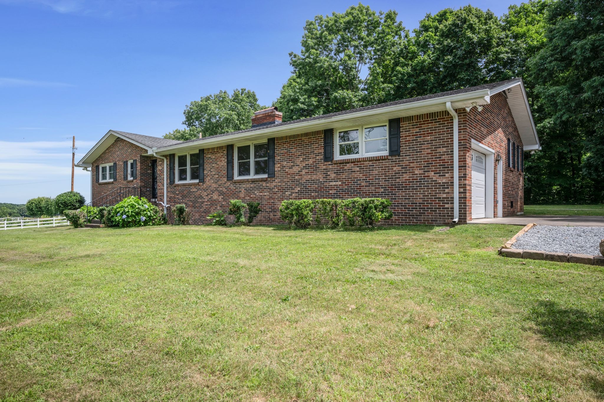 1300 2 Mile Road Burns, TN 37029 - Photo 4 of 38 a front view of a house with garden