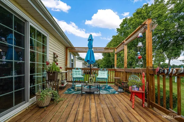 a view of balcony with chairs and wooden floor