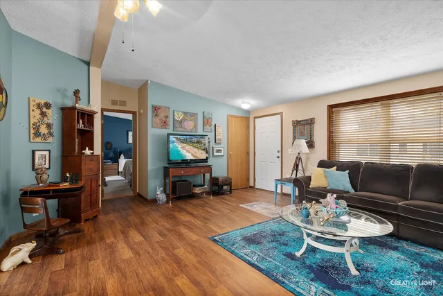 a living room with furniture and wooden floor