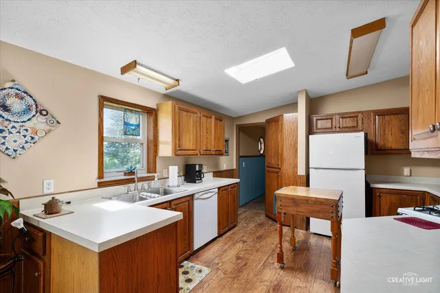 a kitchen that has a sink a table and chairs in it