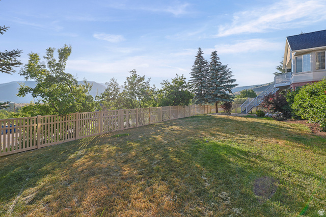 4117 North Wolf Ridge Circle Eden, UT 84310 - Photo 50 of 63 Expansive sloped lawn with a light-toned picket fence