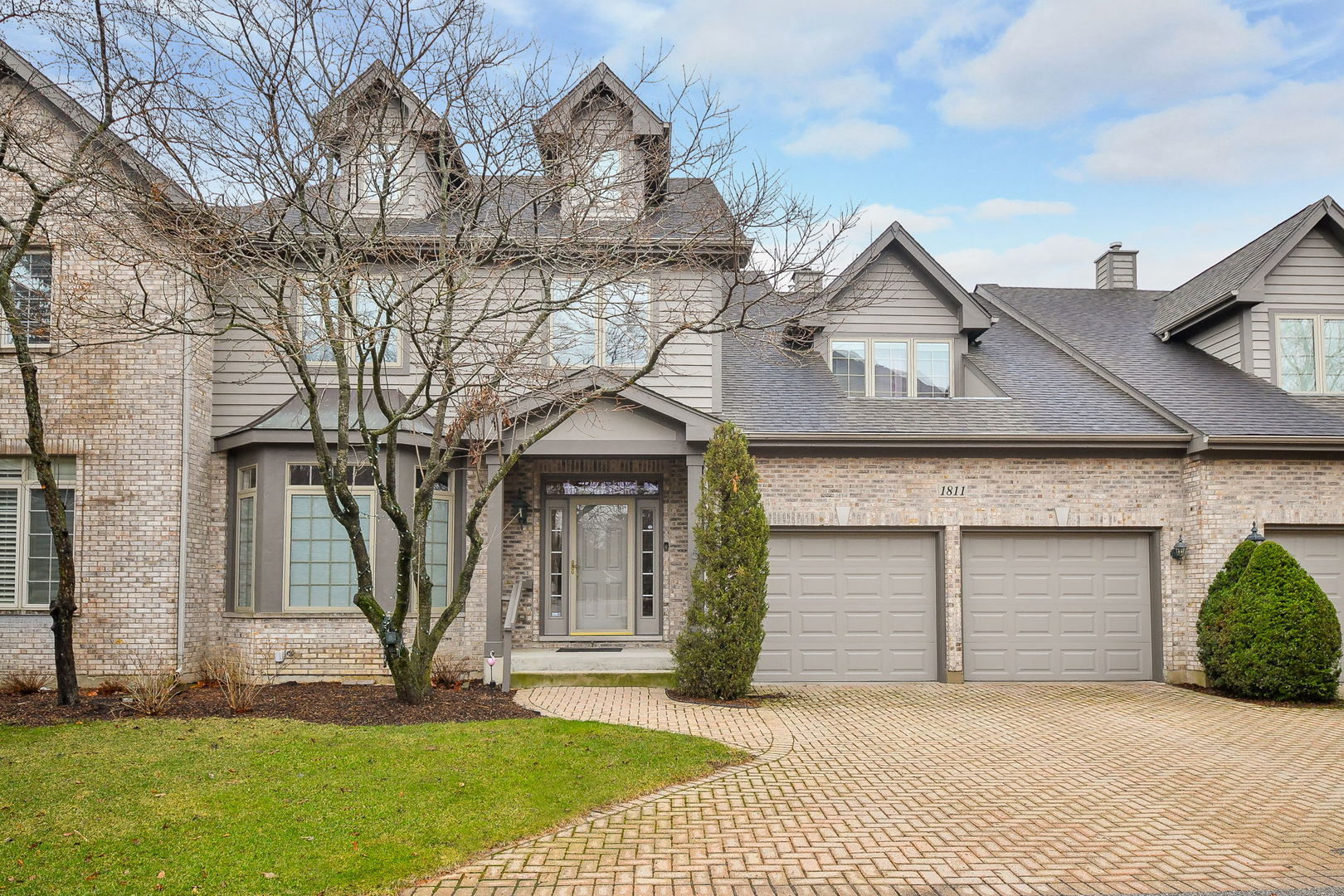 a front view of a house with a garden and yard