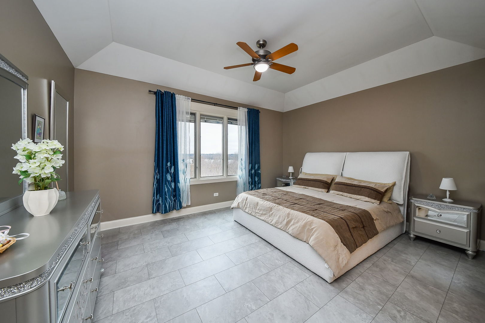 1811 Rizzi Lane, Unit 1811 Bartlett, IL 60103 - Photo 12 of 29 a spacious bedroom with a bed and ceiling fan