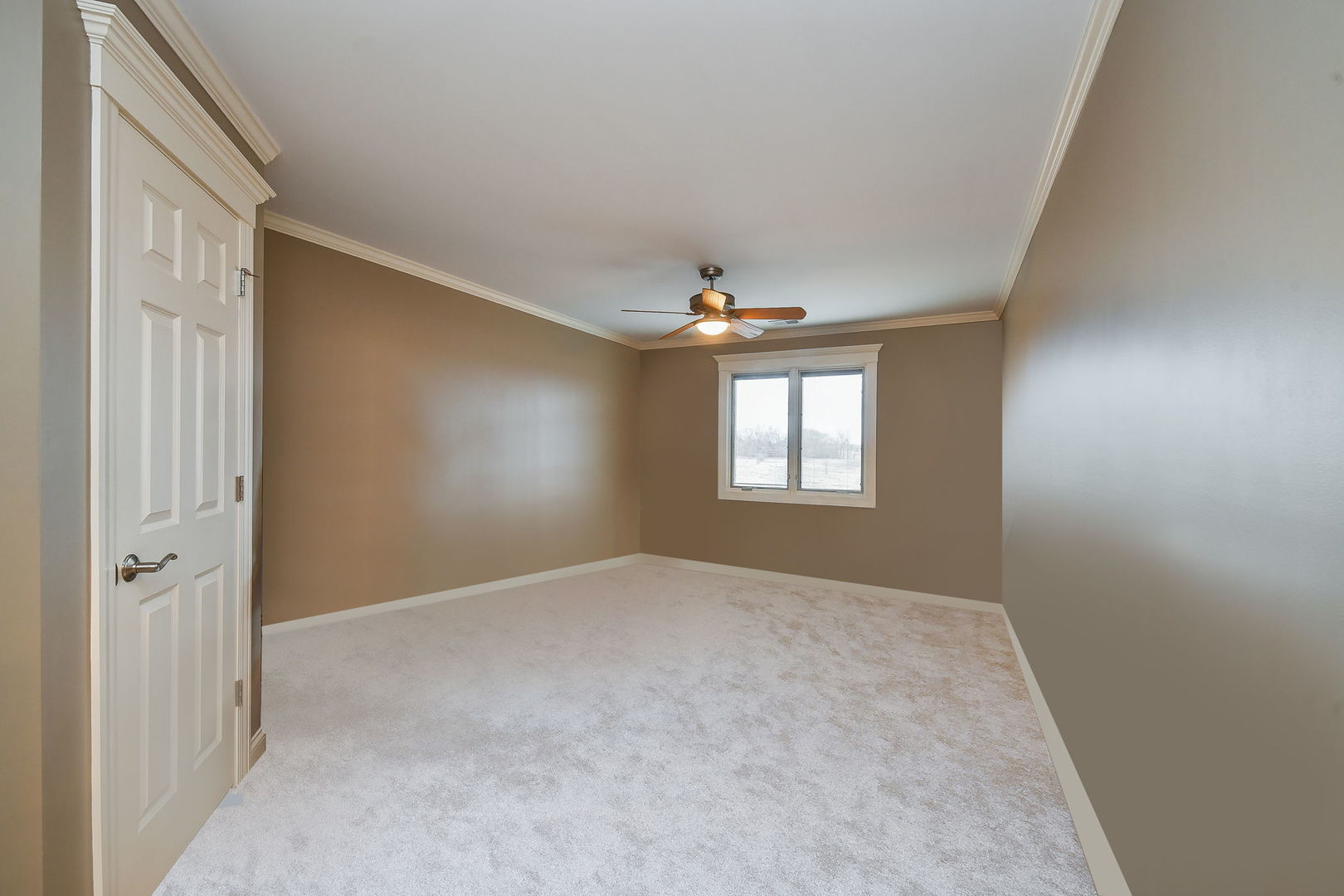1811 Rizzi Lane, Unit 1811 Bartlett, IL 60103 - Photo 19 of 29 an empty room with windows and chandelier fan