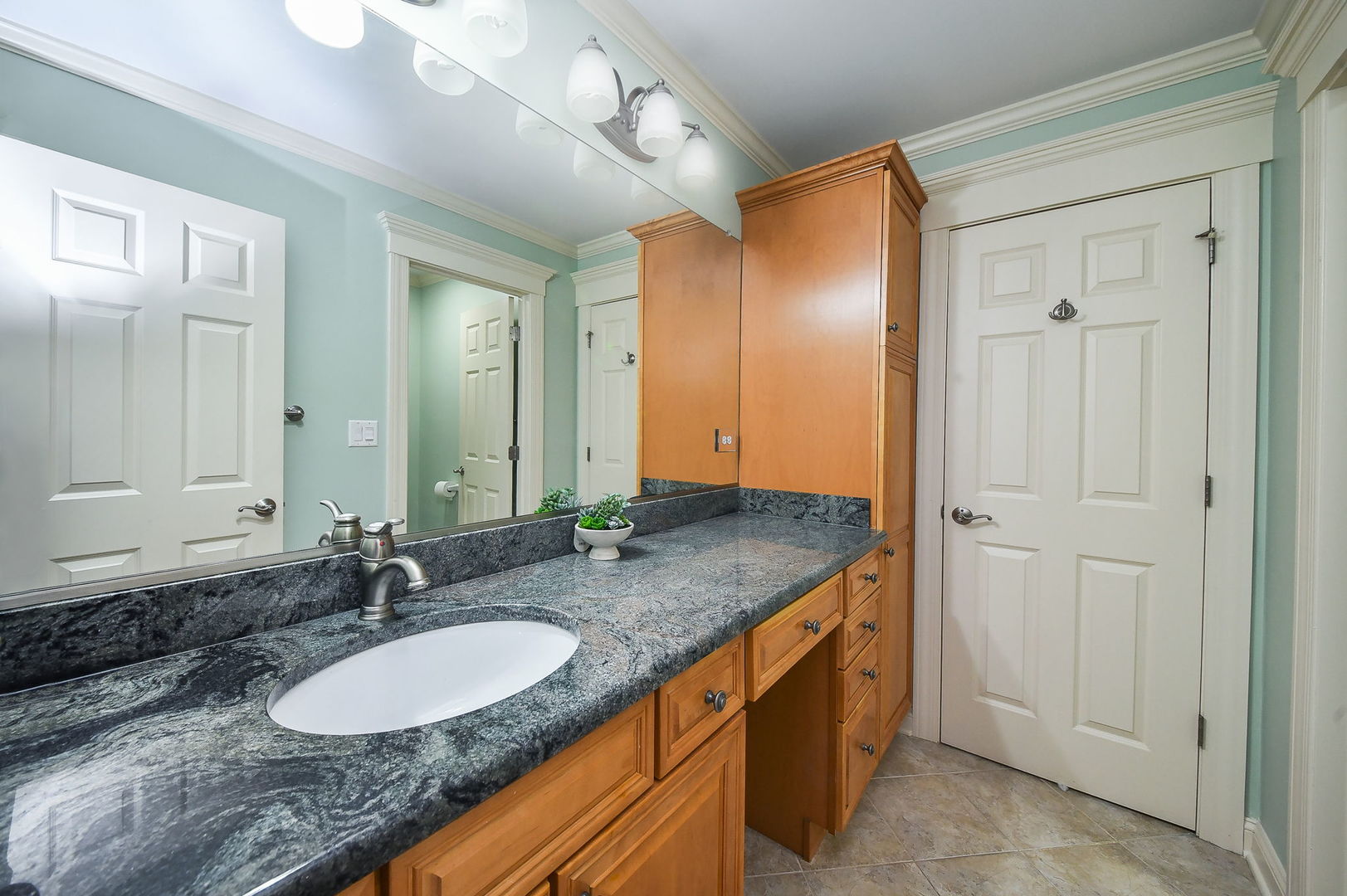 1811 Rizzi Lane, Unit 1811 Bartlett, IL 60103 - Photo 20 of 29 a bathroom with a granite countertop double vanity sink and a mirror