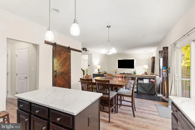 a large kitchen with a table and chairs
