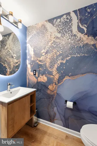 a bathroom with a sink mirror and toilet