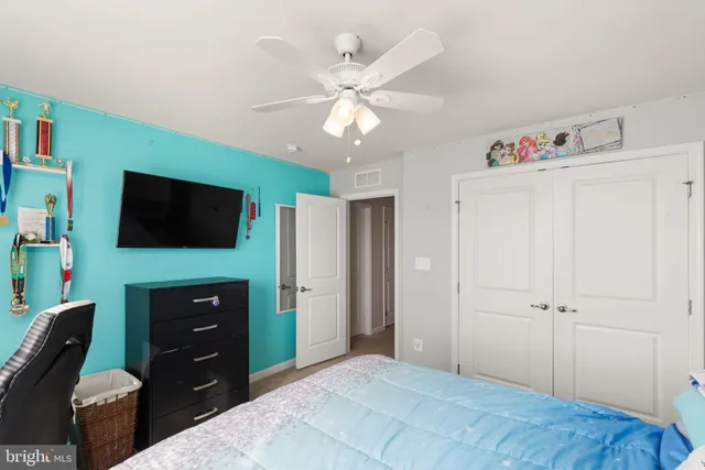 a bedroom with a bed dresser and a window
