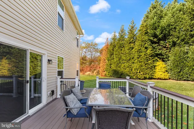 a view of a patio with furniture and a yard